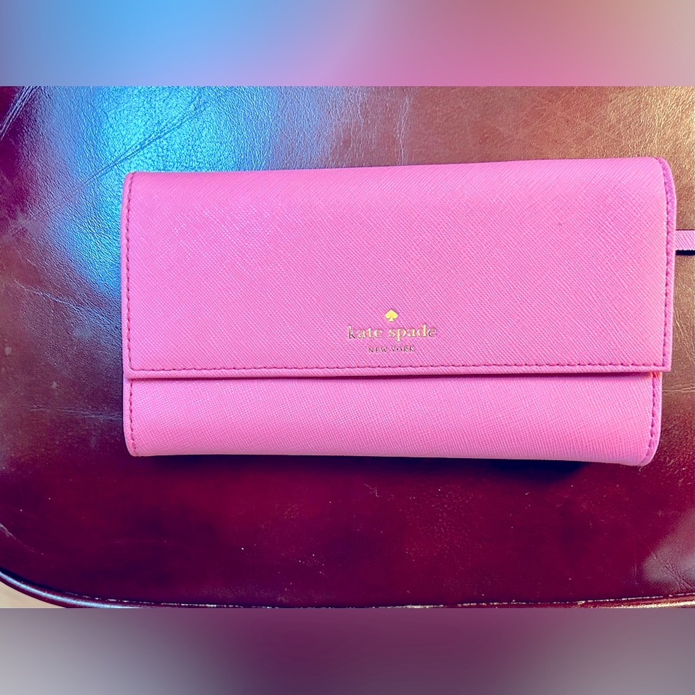 Kate Spade hot pink wallet.  Designed to hold iPhone